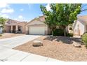 Charming home featuring a two-car garage, desert landscaping, and a concrete driveway at 5 Spur Cross Cir, Henderson, NV 89012