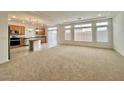 Open-concept living room and kitchen with large windows and sliding glass doors leading to the backyard at 5709 Woodchester Ave, Las Vegas, NV 89139