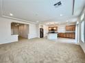 Open-concept living room and kitchen space with recessed lighting and tile flooring in the kitchen at 5709 Woodchester Ave, Las Vegas, NV 89139