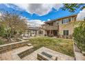Spacious backyard features a lush lawn, patio, gazebo, mature landscaping, and a cozy outdoor fire pit at 5879 Sky Heights Ct, Las Vegas, NV 89135