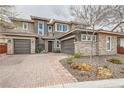 Attractive two-story house featuring two-car garage, stone accents, desert landscaping and a brick driveway at 5879 Sky Heights Ct, Las Vegas, NV 89135