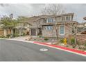 Charming two-story house with a two-car garage, complemented by desert landscaping at 5879 Sky Heights Ct, Las Vegas, NV 89135