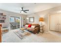 Cozy living room featuring plush seating, ceiling fan, and sliding glass doors to a patio at 6955 N Durango Dr # 3013, Las Vegas, NV 89149