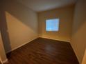 This is a photo of a nice, neutral-colored bedroom with wood floors, a window, and natural light at 10537 Thor Mountain Ln, Las Vegas, NV 89166