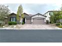 Charming single-story home with a well-manicured lawn and a three-car garage in a quiet neighborhood at 10719 Hammett Park Ave, Las Vegas, NV 89166