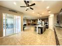 Bright open kitchen with granite counters, stainless appliances, and views of the backyard at 10719 Hammett Park Ave, Las Vegas, NV 89166