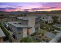 Stunning exterior of a modern home with desert landscaping, mountain views, and stone accents at sunset at 12637 Penfield Ave, Las Vegas, NV 89138