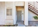 Exterior view of a condo entrance, featuring a secure gated door and stair access at 1300 S Arlington St # 120, Las Vegas, NV 89104
