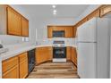 Well-lit kitchen featuring ample wood cabinets, modern appliances, and solid countertops at 1300 S Arlington St # 120, Las Vegas, NV 89104