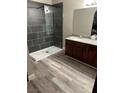 Modern bathroom featuring a spacious walk-in shower and granite countertop vanity at 1911 Bluegill Way # D, Henderson, NV 89014