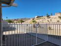 Spacious backyard is fenced with views of desert landscaping and distant hills at 2106 Pebble Creek Ln, Laughlin, NV 89029