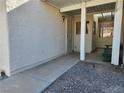 Covered front porch entrance with secure gate and charming architectural details at 2106 Pebble Creek Ln, Laughlin, NV 89029