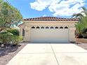 Charming home featuring a two-car garage with decorative windows and a well-maintained driveway at 2119 Sunset Vista Ave, Henderson, NV 89052