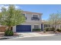 Attractive two-story house with a blue garage door, desert landscaping, and well-maintained front yard at 2367 Tilden Way, Henderson, NV 89074