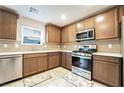 This kitchen features stainless steel appliances, tile backsplash and quartz countertops at 285 Rain Quail Way, Henderson, NV 89012