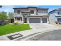 Two-story home features a three-car garage, manicured lawn and classic architecture at 3204 Rutledge Dr, Las Vegas, NV 89120