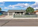 Charming single-story home with a well-manicured lawn, garage, and a modern horizontal fence at 3682 Deer Creek Way, Las Vegas, NV 89115