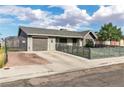 Inviting single-story home with a well-manicured lawn, garage, and brick-lined driveway at 3682 Deer Creek Way, Las Vegas, NV 89115