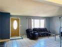 Cozy living room with neutral walls, tile floors, and a bright window at 3766 Colonial Dr, Las Vegas, NV 89121