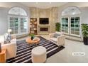 Bright living room with fireplace, built-ins, and double doors to bring the outdoors in at 3957 Placita Del Lazo, Las Vegas, NV 89120