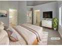 Serene main bedroom features a tiled floor, tv, and ensuite bathroom at 3957 Placita Del Lazo, Las Vegas, NV 89120
