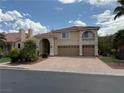 Spacious home with a three-car garage, brick driveway, and a charming balcony, perfect for suburban living at 4139 Abernethy Forest Pl, Las Vegas, NV 89141