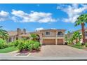 Stunning exterior view of a two-story home with a three car garage and a brick paver driveway at 4139 Abernethy Forest Pl, Las Vegas, NV 89141