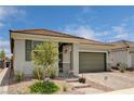 Well-maintained home featuring a stone driveway, manicured landscaping, and a cozy front entrance at 4293 Nopal Serrano Ave, Las Vegas, NV 89141