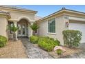 Close up of entrance with double doors, beautiful landscaping and paver walkway at 4311 Fiore Bella Blvd, Las Vegas, NV 89135