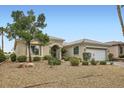 Desert landscaped front yard with a charming stucco home and tiled roof at 4311 Fiore Bella Blvd, Las Vegas, NV 89135