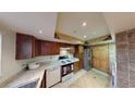 Cozy kitchen featuring ample counter space, stainless steel appliances, and wood cabinets at 4998 Schumann Dr, Las Vegas, NV 89146