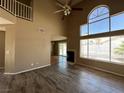 Open living area with high ceilings, fireplace, and wood floors at 5128 Sandstone Dr, Las Vegas, NV 89142