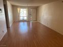Bright living room featuring wood-look floors and a door leading to the outside at 5199 Caliente St # 64, Las Vegas, NV 89119