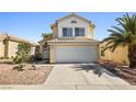 Inviting two-story home with a classic design, well-kept front yard, and a two-car garage at 5332 Desert Blossom Rd, Las Vegas, NV 89107