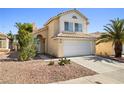 Two-story home featuring a terra cotta roof, neutral stucco, and a two-car garage at 5332 Desert Blossom Rd, Las Vegas, NV 89107