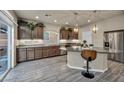 Modern kitchen with stainless steel appliances, granite countertops, and center island with pendant lighting at 5341 Kennedy Hill Ave, Las Vegas, NV 89139