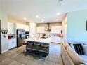 Spacious kitchen boasts a large island with barstool seating and stainless steel appliances at 6021 Vivanco St, North Las Vegas, NV 89081