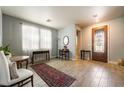 Inviting foyer with tile floors, elegant furnishings, and lots of natural light at 632 Monument Point St, Henderson, NV 89002