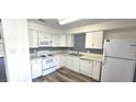 Well-lit kitchen featuring white appliances, ample counter space, and a decorative backsplash at 708 Fernwood Ln, Las Vegas, NV 89169
