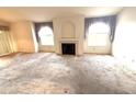 Open-concept living room features a fireplace and lots of natural light at 7570 W Flamingo Rd # 202, Las Vegas, NV 89147
