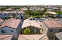 Overhead view of a single Gathering home, showing roof, yard, and proximity to park in a dense suburban neighborhood at 7694 Hampton Park Ln, Las Vegas, NV 89113