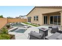 Resort-style backyard featuring a sparkling pool, spa, covered patio, and ample seating for outdoor entertaining at 8956 Skye Treeline St, Las Vegas, NV 89166