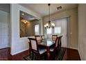 Elegant dining room featuring a modern chandelier, hardwood floors, and a spacious layout at 9209 Tudor Park Pl, Las Vegas, NV 89145