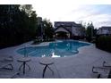 Inviting community pool with lounge chairs and mature trees, perfect for relaxation at 9209 Tudor Park Pl, Las Vegas, NV 89145
