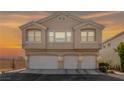 A home's front exterior with three garage doors below and three visible windows above at 9312 Straw Hays St # 103, Las Vegas, NV 89178