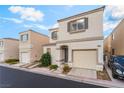 Charming two-story home featuring a tan exterior, well-kept landscaping, and an attached garage at 9962 Keephills St, Las Vegas, NV 89183