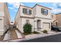 Charming two-story home featuring a tan exterior, well-kept landscaping, and an attached garage at 9962 Keephills St, Las Vegas, NV 89183