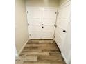 Inviting entryway with wood-look flooring and white painted double doors at , Las Vegas, NV 89121