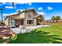 Spacious backyard featuring a covered patio and lush green lawn with views of the surrounding landscape at 1131 Golf Club, Laughlin, NV 89029
