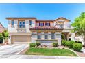Spacious two-story home featuring a red-tile roof, balconies, well-maintained landscaping, and an attached two-car garage at 1235 Panini Dr, Henderson, NV 89052